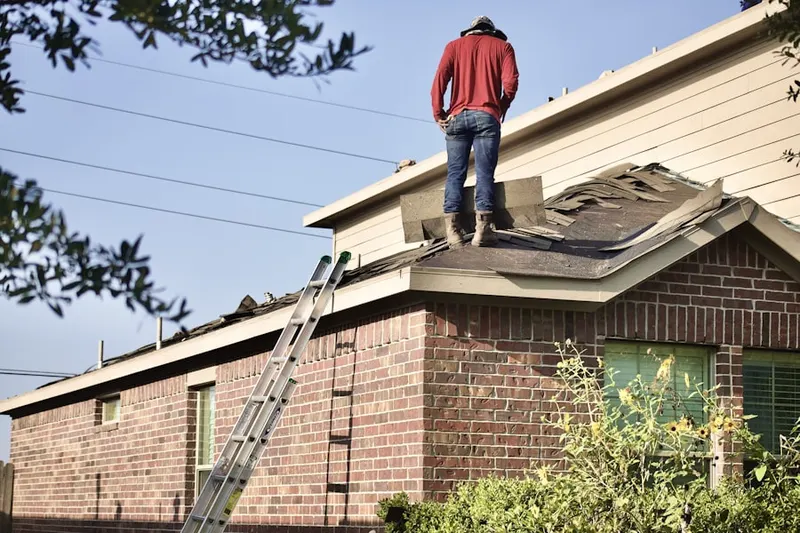 Professional roofer working on a residential roof in Podunk